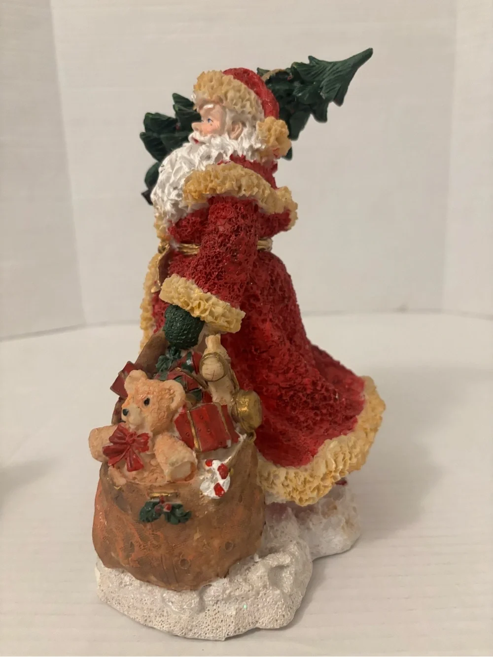 Festive Red Santa Figurine with Green Tree and Brown Toy Sack